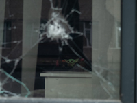 A puppet is seen through a window shot by gunfire, inside an office in the city center of Mykolaiv, Ukraine.(