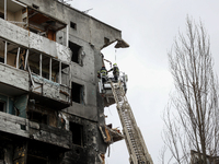 A rescuers search for bodies under the rubble of a building destroyed by Russian shelling, amid Russia's Invasion of Ukraine, in Borodyanka,...