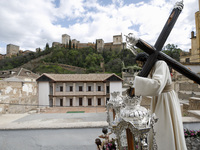 The image of Padre Jesus del Amor with a view of the Alhambra monument during the Maundy Thursday in Granada, Spain, on April 14, 2022.Holy...