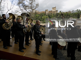 A music band of the Holy Week with a background view of the Alhambra monument during the Maundy Thursday in Granada, Spain, on April 14, 202...
