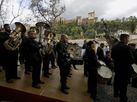 A music band of the Holy Week with a background view of the Alhambra monument during the Maundy Thursday in Granada, Spain, on April 14, 202...