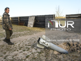 Local resident  Olexii stands near the detail of a rocket missile in a village in the north of Kyiv, Ukraine, 14 April 2022 (