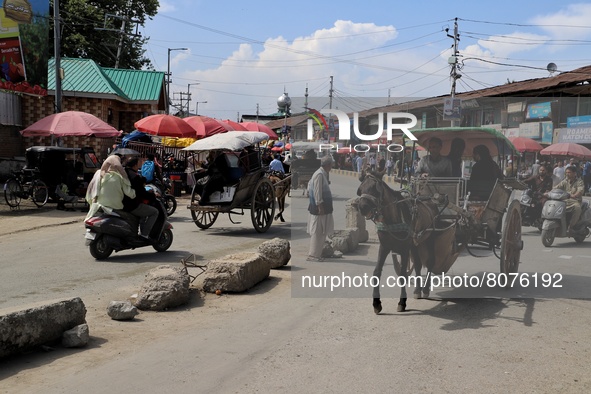 Concrete boulders are kept as road Divider as a Horse carrier moves through Iqbal Market in Sopore, Baramulla, Jammu and Kashmir, India on 1...