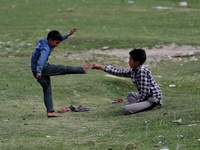 Kashmiri boys fight playfully in a ground in Sopore, Baramulla, Jammu and Kashmir, India on 15 April 2022. (