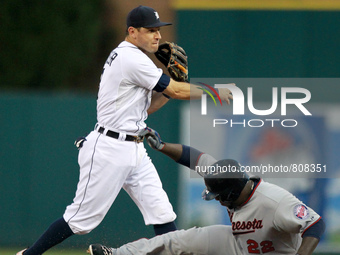 Minnesota twins ' Miguel Sano slides under the tag by Detroit Tigers second baseman Ian Kinsler during the first inning of a baseball game i...