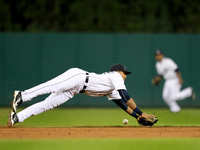 Detroit Tigers' Dixon Machado could not catch the ball after diving for a ball off the bat of Minnesota twins' Miguel Sano during the third...