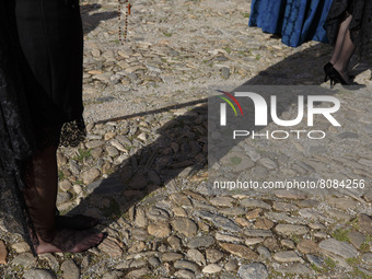 A penitent from the Santa Maria de la Alhambra Brotherhood dressed in black is barefoot during the Holy Saturday in Granada, Spain, on April...