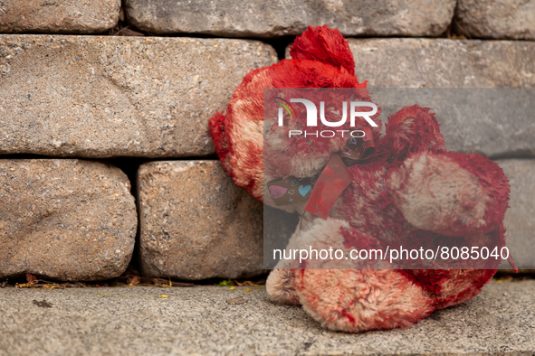 A teddy bear covered in fake blood sits outside the residence of the Russian ambassador to the United States during a protest against the wa...