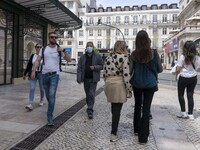 People wearing protective masks are seen walking around Rossio square. Lisbon, 17 April 2022. Covid-19 deaths in Portugal are stabilising, b...
