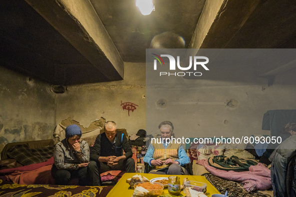 Civilians wait in  a shelter during a russian shelling over the village of Luch, a village close to the frontline in the Mykolaiv region, Uk...