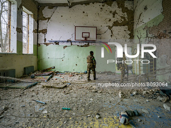 Ukrainian soldiers check the sport center of a school in  the village of Luch, a village close to the frontline in the Mykolaiv region, Ukra...