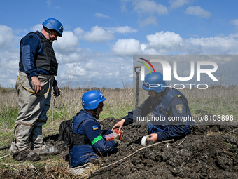 HRYHORIVKA, UKRAINE - APRIL 20, 2022 - Experts of a State Emergency Service bomb squad work to dispose of the dangerous remains of an Uragan...