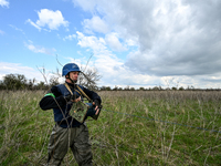 HRYHORIVKA, UKRAINE - APRIL 20, 2022 - An expert of a State Emergency Service bomb squad holds a roll of the wire during an effort to dispos...