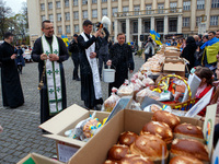UZHHOROD, UKRAINE - APRIL 21, 2022 - A priest blesses paskas that will be sent to the Ukrainian military with holy water ahead of Easter tha...