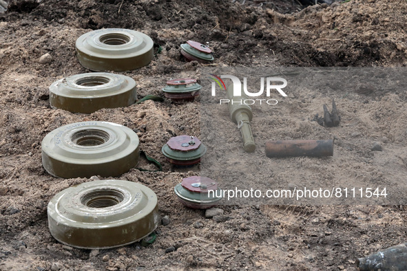 KYIV REGION, UKRAINE - APRIL 21, 2022 - Ammunition is arranged on the ground during a mine clearance mission near Bervytsia, a village liber...