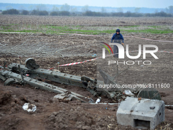 KYIV REGION, UKRAINE - APRIL 21, 2022 - An EOD expert of the State Emergency Service crosses the field during a mine clearance mission near...