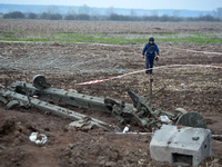 KYIV REGION, UKRAINE - APRIL 21, 2022 - An EOD expert of the State Emergency Service crosses the field during a mine clearance mission near...