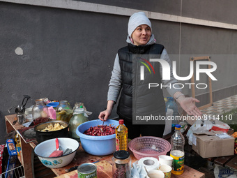 IRPIN, UKRAINE - APRIL 20, 2022 - Local resident Anna Myronenko, who returned to the city a few days ago, helps to cook food in the yard of...