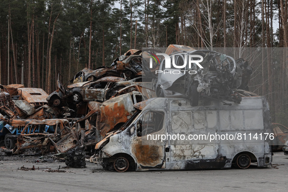 IRPIN, UKRAINE - APRIL 20, 2022 - Cars destroyed as a result of Russian shelling are piled at a parking lot in Irpin that was liberated from...