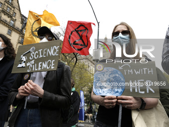 People march through the streets with signs chanting slogans in support of science and the scientific research on April 23, 2022 in New York...