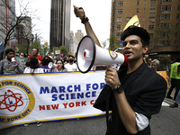 People march through the streets with signs chanting slogans in support of science and the scientific research on April 23, 2022 in New York...