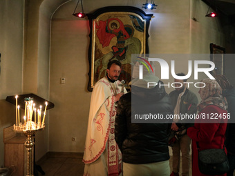 BUCHA, UKRAINE - APRIL 24, 2022 - A priest talks to devotees during an Easter liturgy in the Church of Saint Andrew the First-Called Apostle...