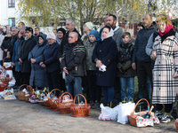 BUCHA, UKRAINE - APRIL 24, 2022 - People wait for their baskets to be consecrated with holy water outside the Church of Saint Andrew the Fir...
