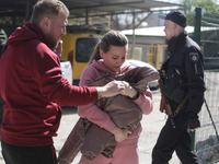 A local woman holds her rescued cat near a residential building which was hit by a missile strike in Odesa, Ukraine 24 April, 2022. On 23 Ap...