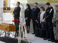 Relatives and friends attend a funeral ceremony of 3 month-old Kira Glodan, her mother Valeriya Glodan and grandmother Ludmila Yavkina, at t...