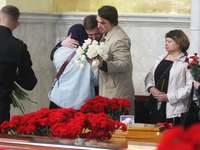 Relatives and friends react during a funeral ceremony of 3 month-old Kira Glodan, her mother Valeriya Glodan and grandmother Ludmila Yavkina...