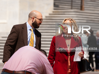 Marjorie Taylor Greene (R-GA) talks with a member of her staff en route to a press conference on the 21st Century Free Speech Act that she h...