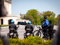 Capitol Police wait to escort a departing VIP minutes before a press conference on free speech by Congresswoman Marjorie Taylor Greene (R) o...
