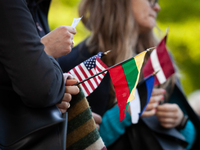 Protesters hold the flags of the United States, Lithuania, Estonia, and Latvia (left to right) during a rally at the White House against Rus...