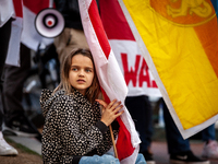 A young girl holds a Belarusian flag during a rally at the White House  against Russia's war in Ukraine.  The Belarusian community in the Wa...