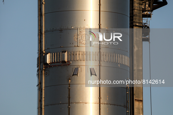 Starship's Super Heavy booster is seen at sunset at SpaceX's South Texas launch facility in Boca Chica, Texas on April 28th, 2022.  