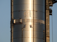 Starship's Super Heavy booster is seen at sunset at SpaceX's South Texas launch facility in Boca Chica, Texas on April 28th, 2022.  (