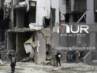 Rescuers carry the body of Radio Liberty producer Vira Hyrych, who was killed in an air strike, from an apartment block destroyed in a rocke...