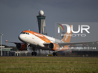 Airplane is flying in front of the control tower. EasyJet Europe Airbus A319 aircraft as seen during taxiing, rotate and take off phase flyi...