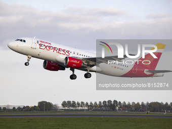 Iberia Express Airbus A320 aircraft as seen departing from Amsterdam Schiphol AMS EHAM airport. The passenger jet plane is passing in front...
