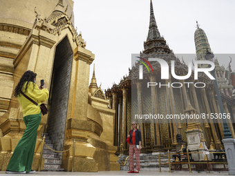 A foreign tourist poses for a photo during a visit at the Temple of the Emerald Buddha in Bangkok, Thailand, 01 May 2022. Thailand allowing...