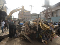 An excavator packs rubbles on the road side at the site of a 3 –storey building collapse at Ibadan Street along Herbert Macaulay way in the...