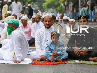A Father and his sons are seen waiting ahead of Eid-ul-fitr prayer in Kolkata , India , on 3 May 2022 .Muslim community of Kolkata observes...