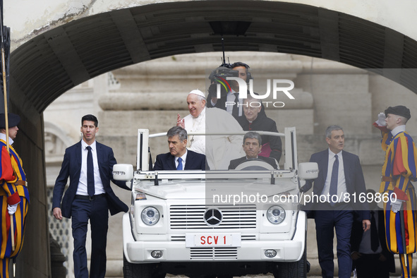 Pope Francis arrives on the popemobile to attend his weekly open-air general audience in St. Peter's Square at The Vatican, Wednesday, May 4...