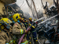 Firefighters responds on a fire hits residential area in Manila, Philippines on May 4, 2022. 4th of May is the celebration of International...