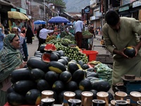 People purchase vegetables and fruits from a market in Baramulla Jammu and Kashmir India on 06 May 2022 (