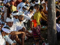 Balinese Hindu devotees gather as they perform prayers during the Melasti, a purification ceremony ahead of Nyepi at a beach in Bali, Indone...