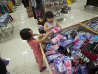 An Iranian young girl looks on a pencil case while shopping with her mother (not pictured) in Tehran's Megamall on September 30, 2013. (