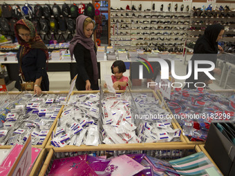 Iranian women and their young daughters attend Tehran's Megamall for shopping on September 30, 2013. (