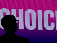 The word CHOICE on a LED billboard is seen through the glasses of PA Governor Tom Wolf as hundreds gather at a Democrats Defends Choice Rall...