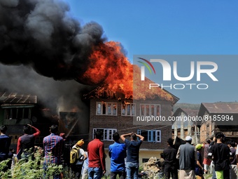 People watch as several houses Gutted in Fire Incident in Baramulla, Jammu and Kashmir India on 07 May 2022 (